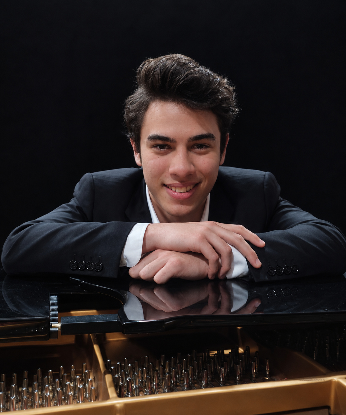 Benjamin Carter leaning on a grand piano